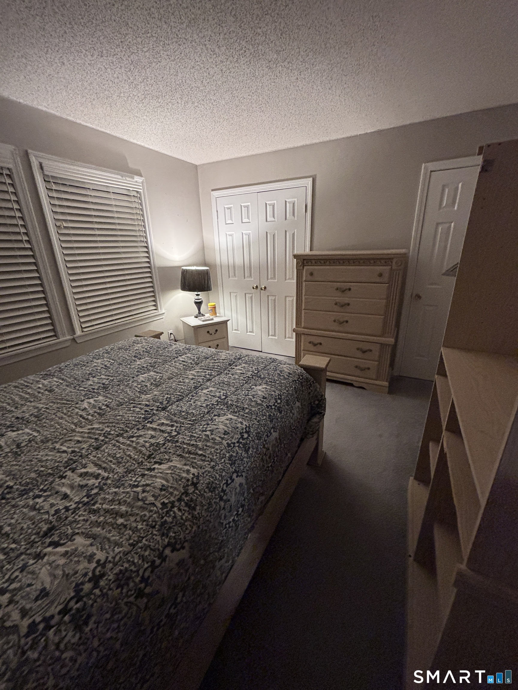 101 Madeline Avenue, Unit 33 Waterbury, CT 06708 - Photo 27 of 41 a bedroom with a bed next to a window