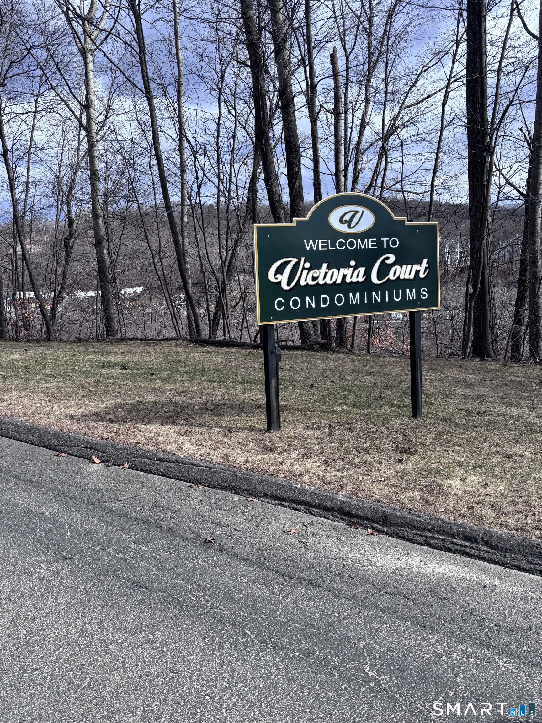 101 Madeline Avenue, Unit 33 Waterbury, CT 06708 - Photo 4 of 41 a view of a street sign under a large tree