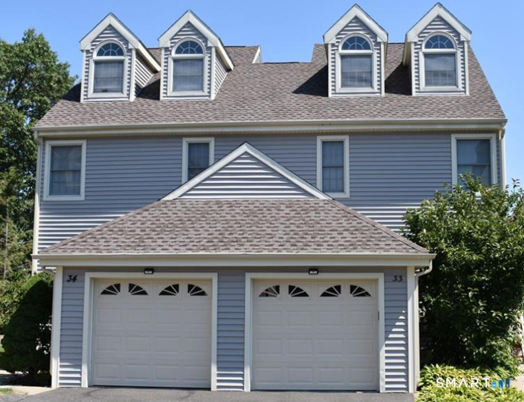 101 Madeline Avenue, Unit 33 Waterbury, CT 06708 - Photo 5 of 41 a front view of a house with a garden