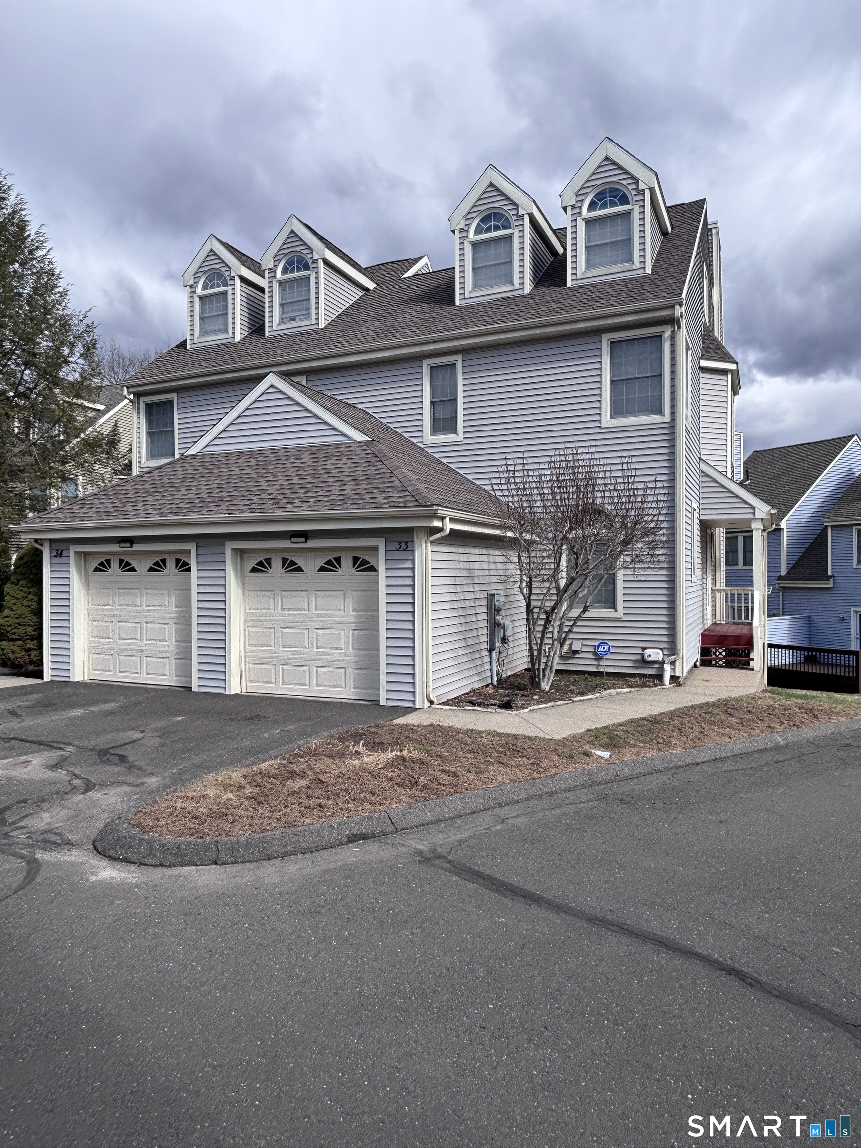 101 Madeline Avenue, Unit 33 Waterbury, CT 06708 - Photo 6 of 41 a front view of a house with a road