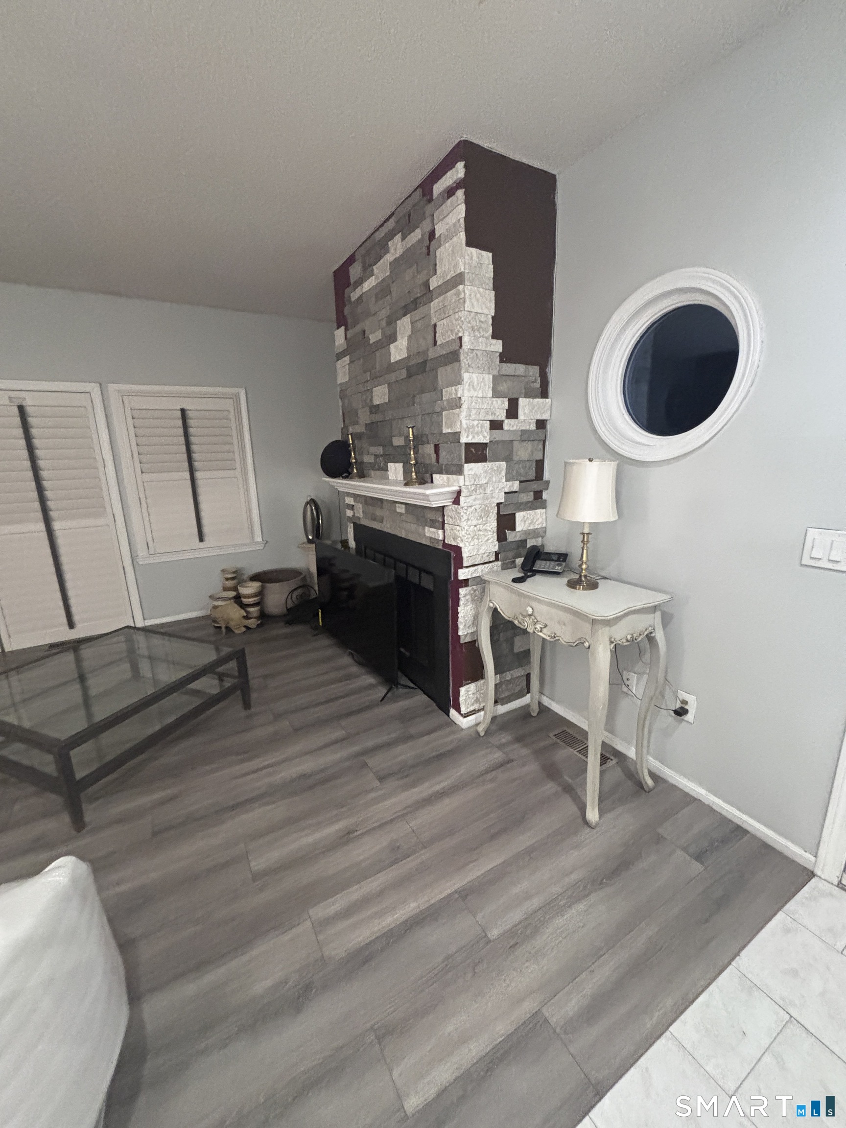 101 Madeline Avenue, Unit 33 Waterbury, CT 06708 - Photo 7 of 41 a living room with furniture a rug and a wall painting