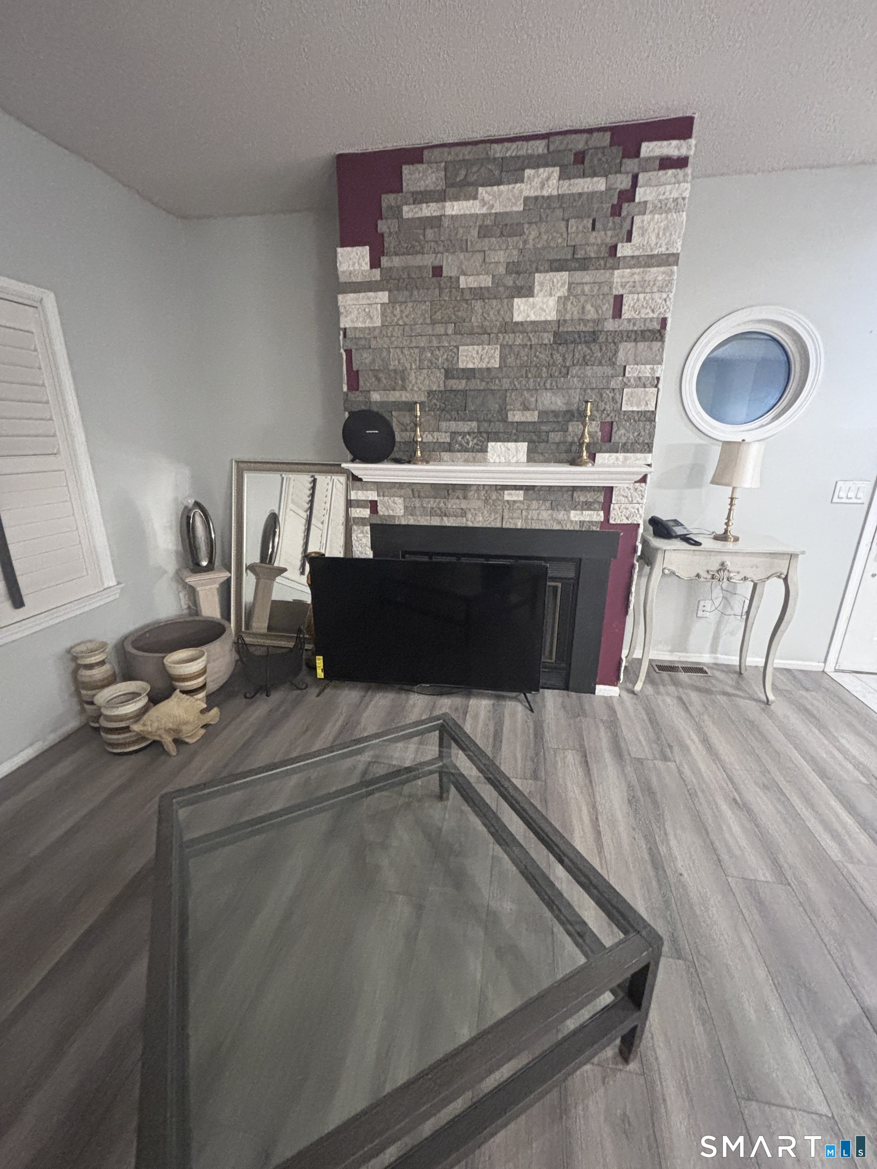 101 Madeline Avenue, Unit 33 Waterbury, CT 06708 - Photo 9 of 41 a living room with a couch and a table