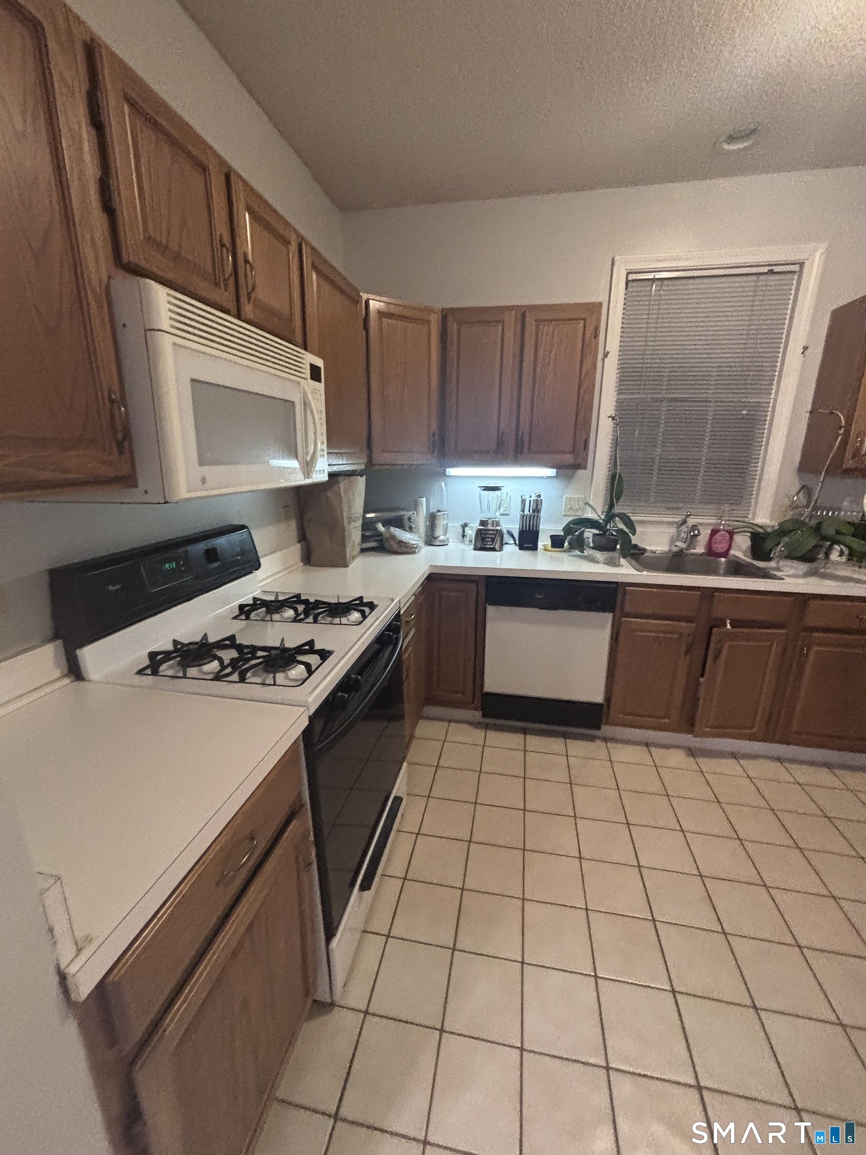 101 Madeline Avenue, Unit 33 Waterbury, CT 06708 - Photo 10 of 41 a kitchen with a sink a stove and a refrigerator