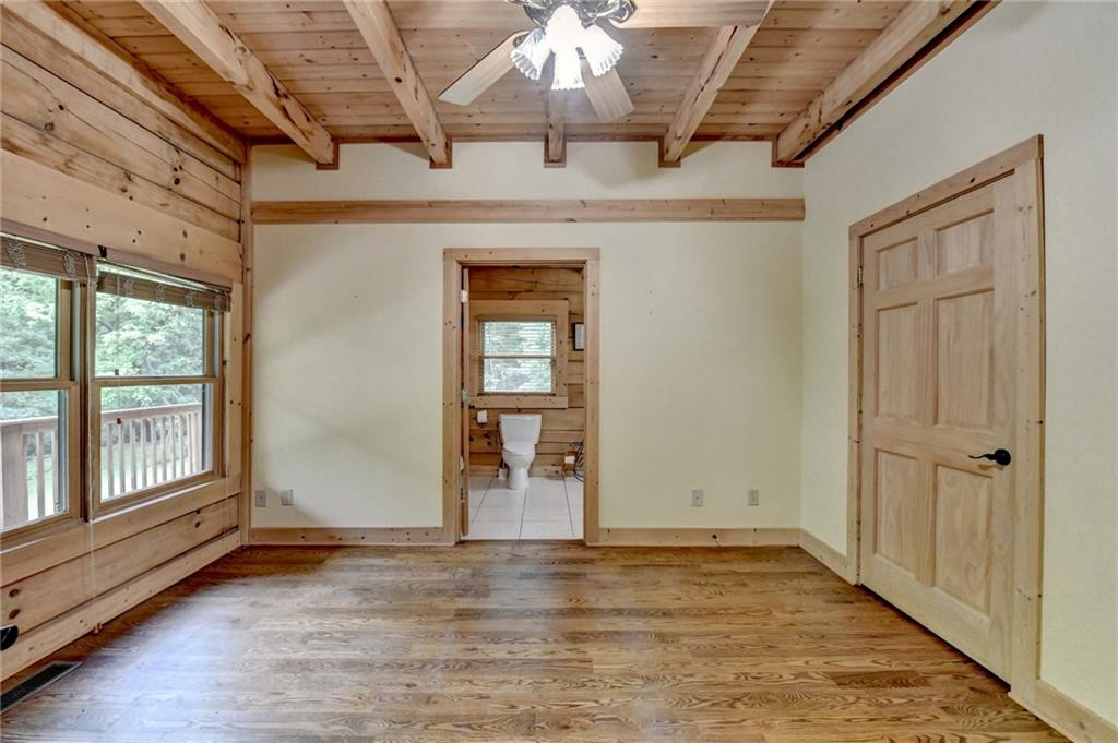 82 Walnut Grove Lane Tiger, GA 30576 - Photo 39 of 88 an empty room with wooden floor chandelier and windows