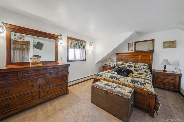 a bed room with furniture and a mirror