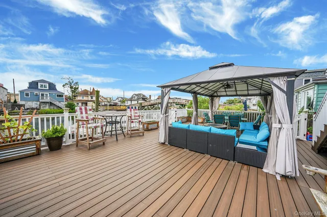 a view of a chair and tables in the balcony