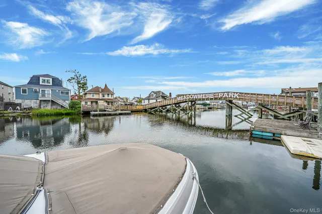 a view of a roof deck with dining table and chairs