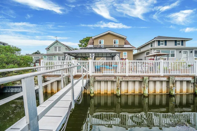 a living room with furniture and a ceiling fan