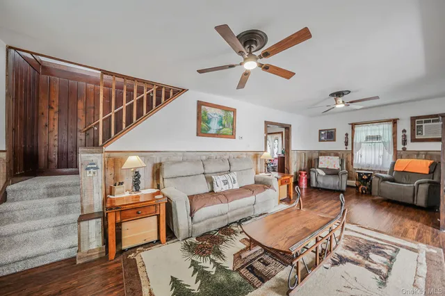 a living room with furniture and a ceiling fan