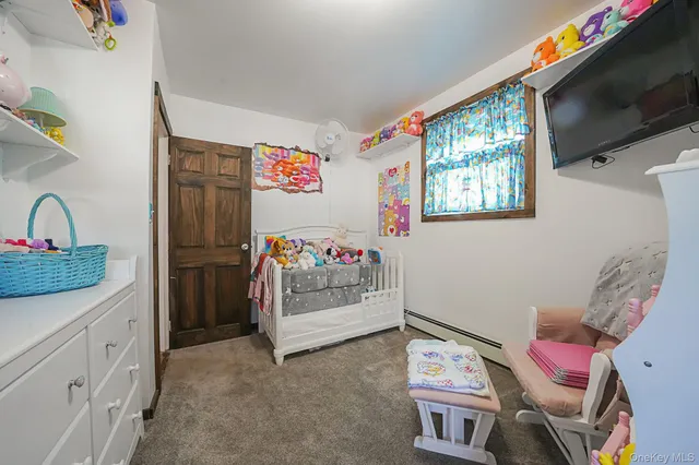 a view of room with window and furniture