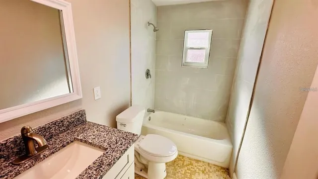 a bathroom with a bathtub and toilet