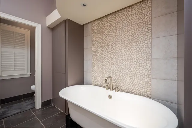 a bathroom with a white bath tub and a sink