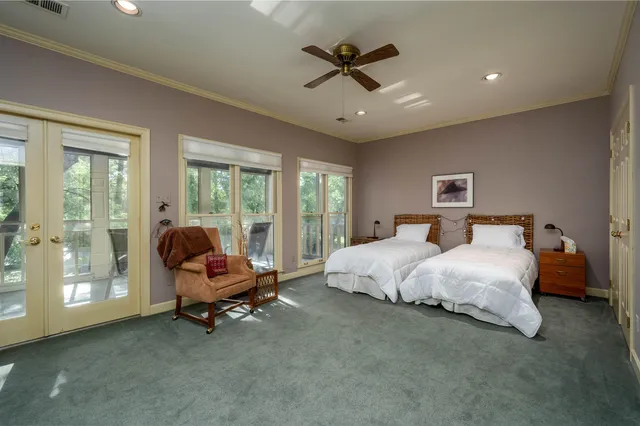 a bed room with a bed and a chair