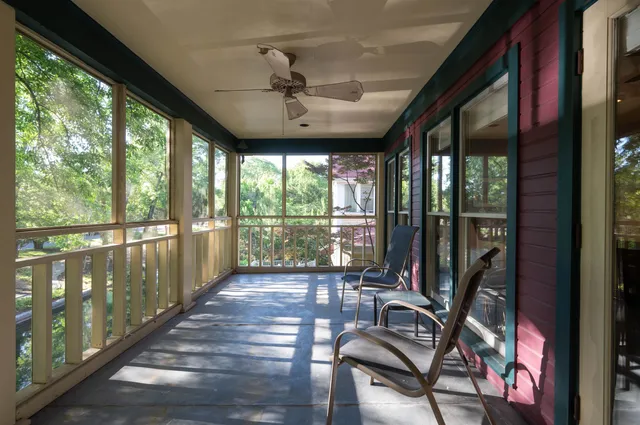 a view of a room with wooden floor and windows