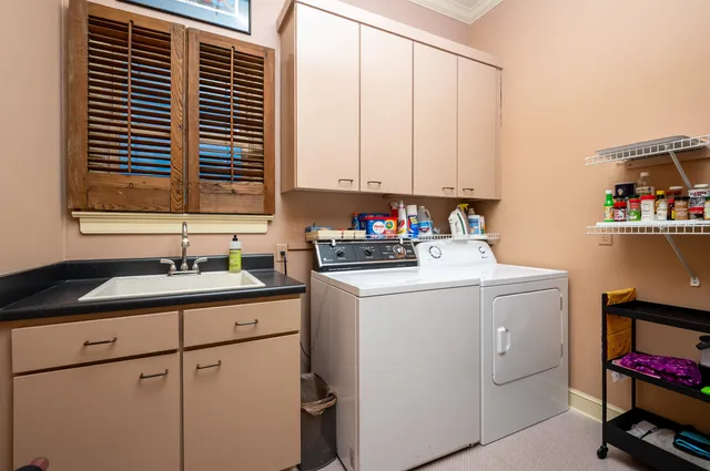 a kitchen with a sink cabinets and window