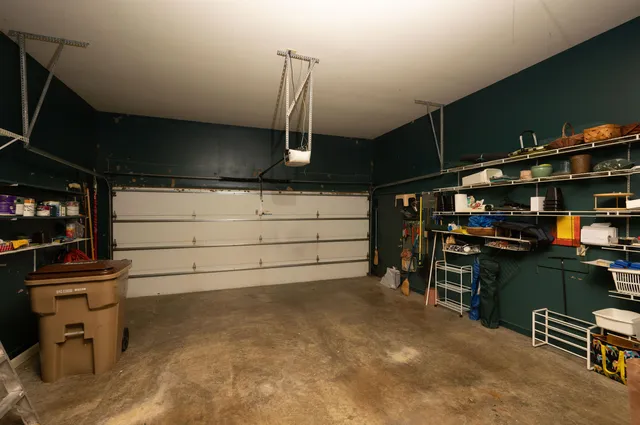 a view of a house with brick walls and flower plants