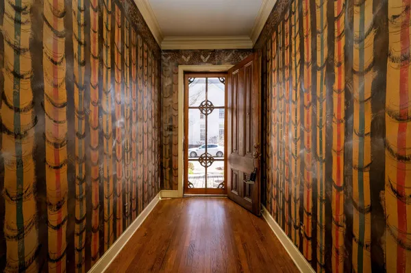 a view of hallway with wooden floor and stairs