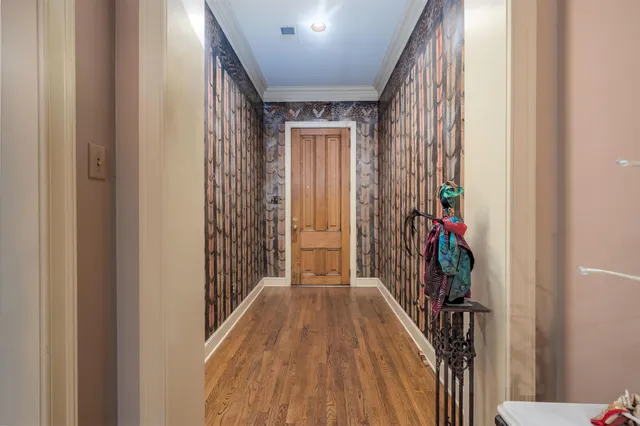 a view of hallway with wooden floor