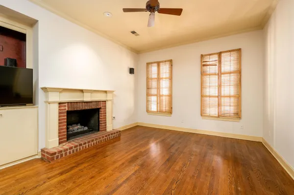 a living room with a fireplace and a flat screen tv