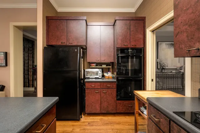a kitchen with a refrigerator and a sink