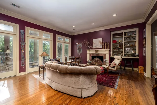 a living room with furniture a fireplace and a wooden floor
