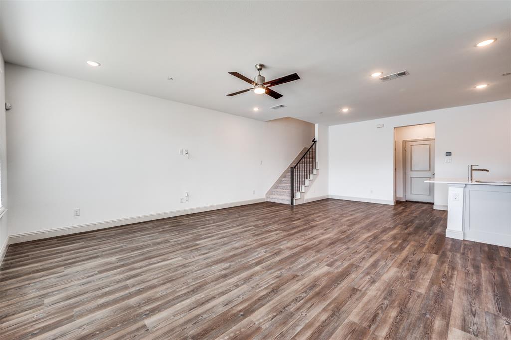 15866 Yellow Elder Road Frisco, TX 75035 - Photo 5 of 25 a view of an empty room with wooden floor and a ceiling fan