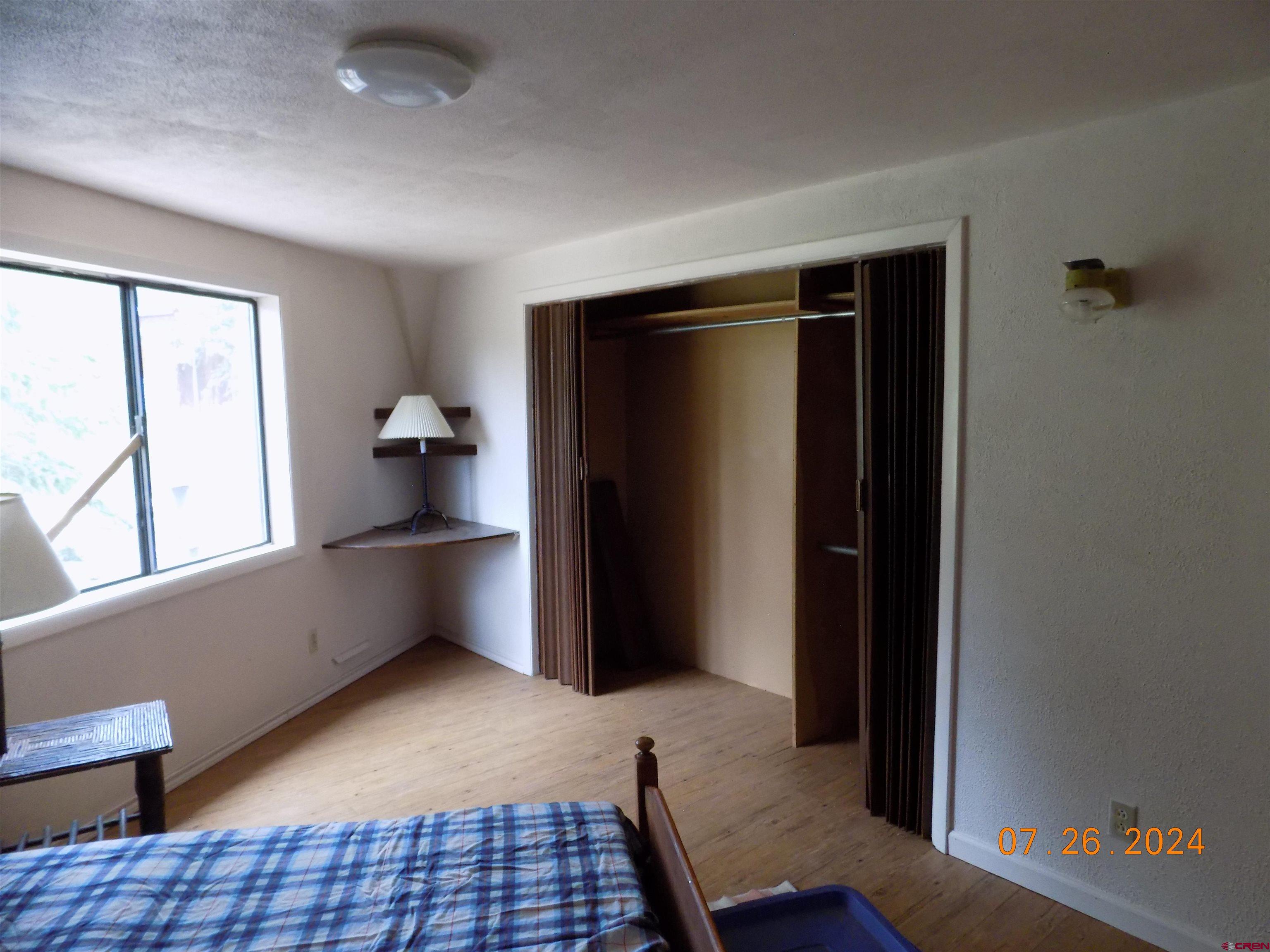 95 Geneva Loop Pitkin, CO 81241 - Photo 11 of 14 a view of empty room with wooden floor and fan
