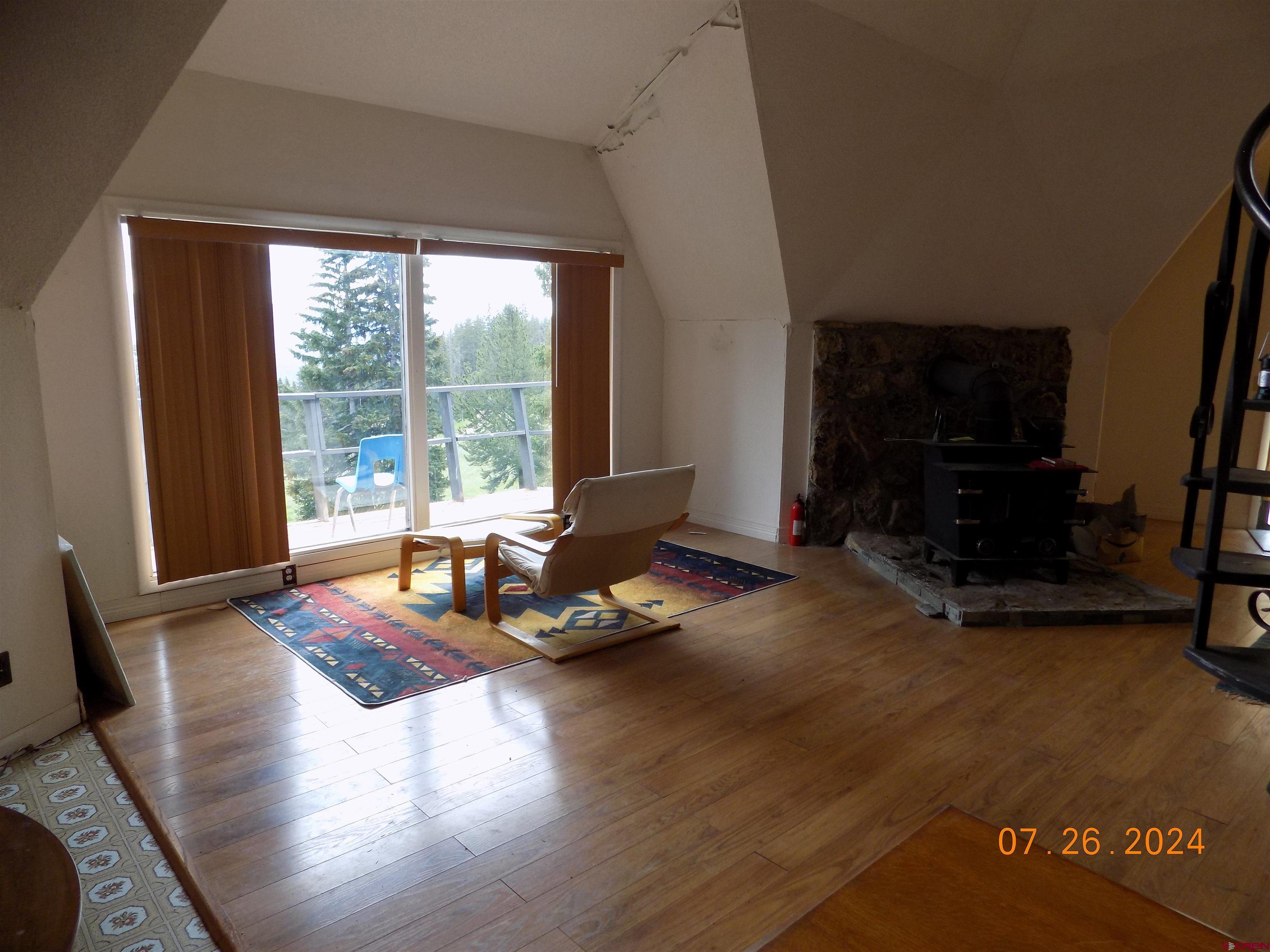 95 Geneva Loop Pitkin, CO 81241 - Photo 5 of 14 a living room with patio furniture and a floor to ceiling window