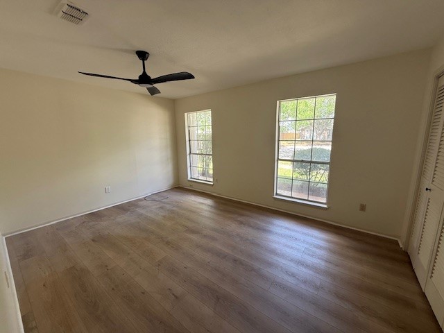 6410 Clearlake Circle Corpus Christi, TX 78413 - Photo 10 of 20 an empty room with wooden floor fan and windows