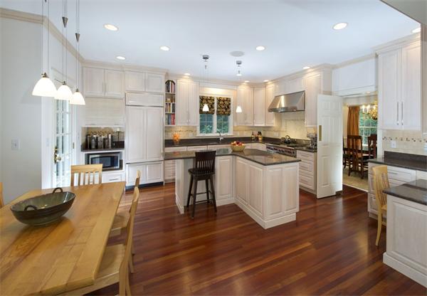 39 Windsor Road Wellesley, MA 02481 - Photo 6 of 23 a kitchen with stainless steel appliances granite countertop a stove top oven a sink dishwasher a dining table and chairs with wooden floor