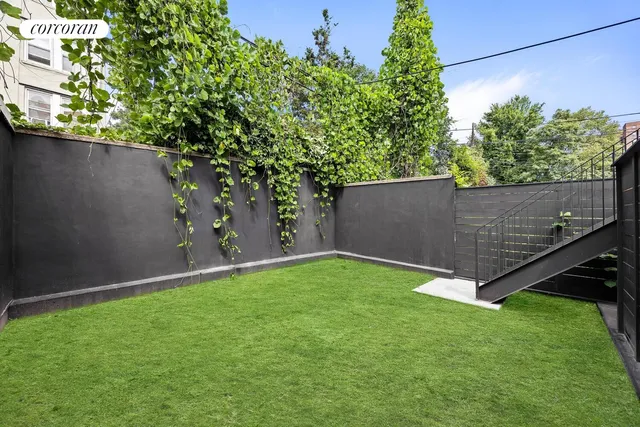 a view of a backyard with a tree