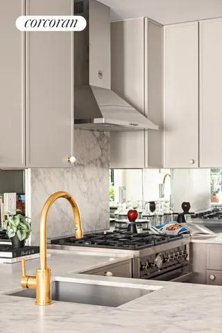 a kitchen with stainless steel appliances granite countertop a sink dishwasher and a stove with wooden floor