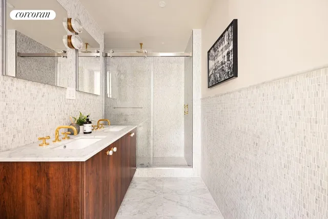 a bathroom with a sink a mirror and a shower