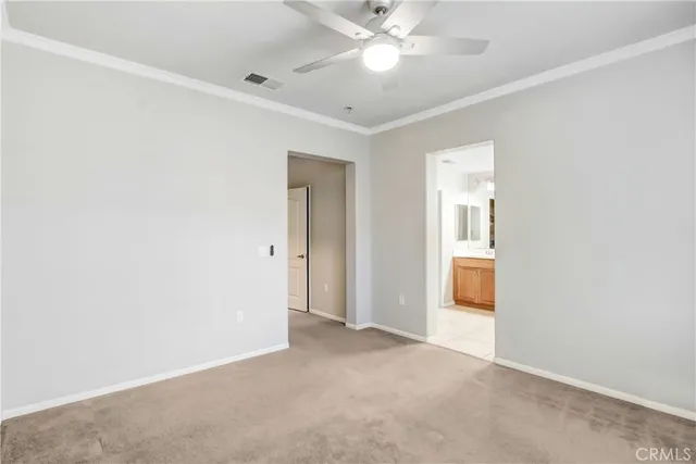 a view of a room with a ceiling fan