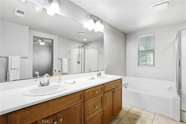 a bathroom with a tub double sink and mirror