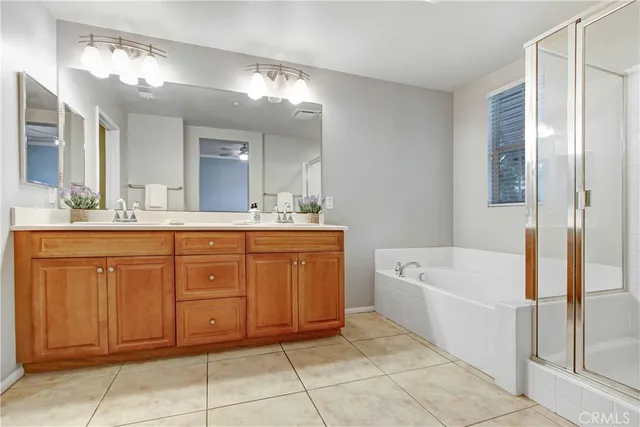 a spacious bathroom with a tub sink and mirror