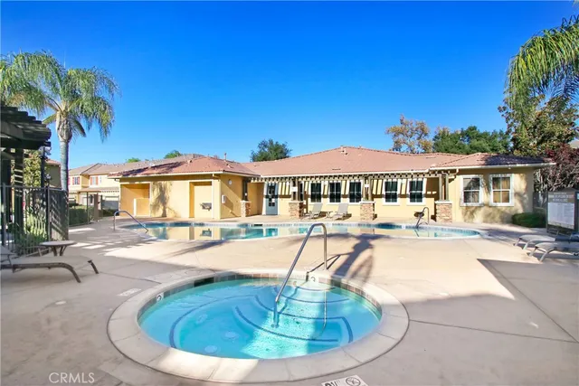 a view of a house with swimming pool and sitting area