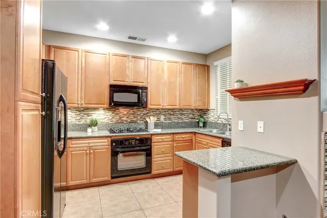 a kitchen with stainless steel appliances granite countertop a sink and a microwave