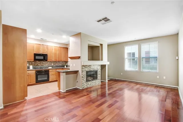 a kitchen with granite countertop a stove top oven a sink and a microwave