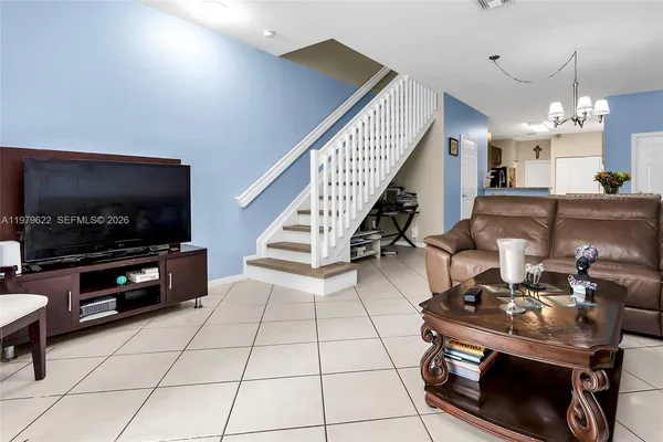 a living room with furniture and a flat screen tv