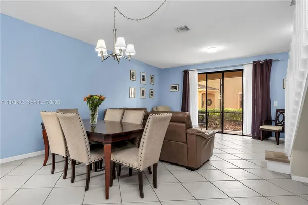 a dining room with furniture and a chandelier