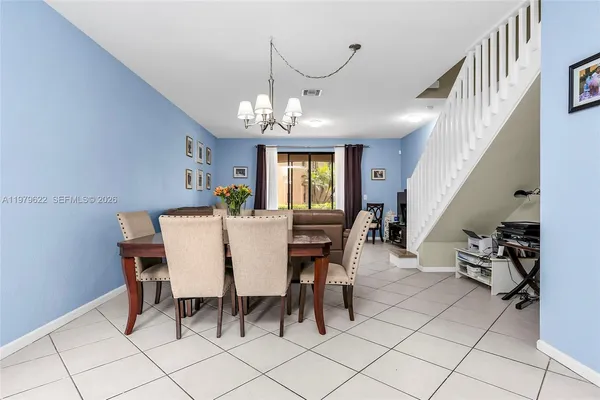 a view of a dining room with furniture and chandelier