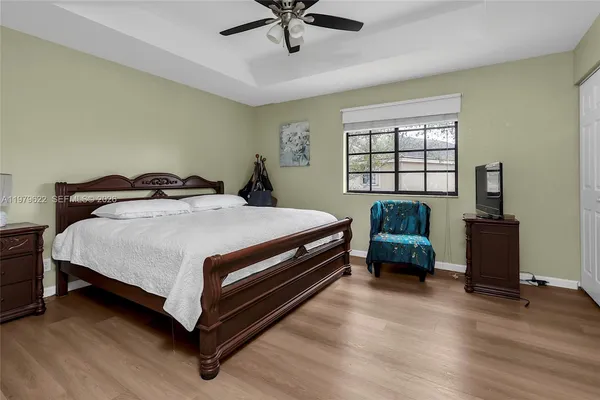 a bedroom with a bed and a couch