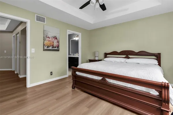a bedroom with a bed and wooden floor