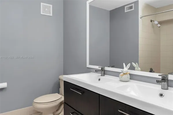 a bathroom with a sink toilet and a mirror