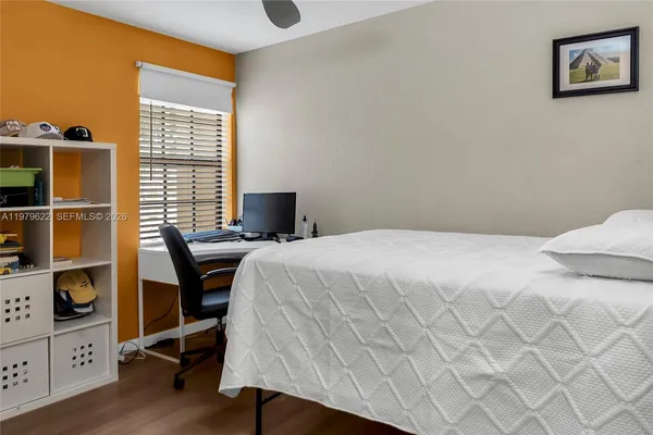 a bedroom with a bed and a desk in it