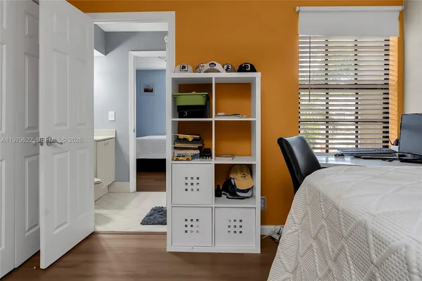 a bedroom with a bed and a window