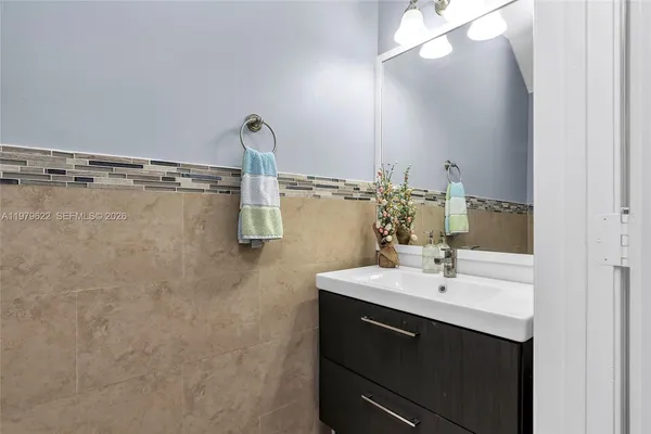 a bathroom with a sink and mirror