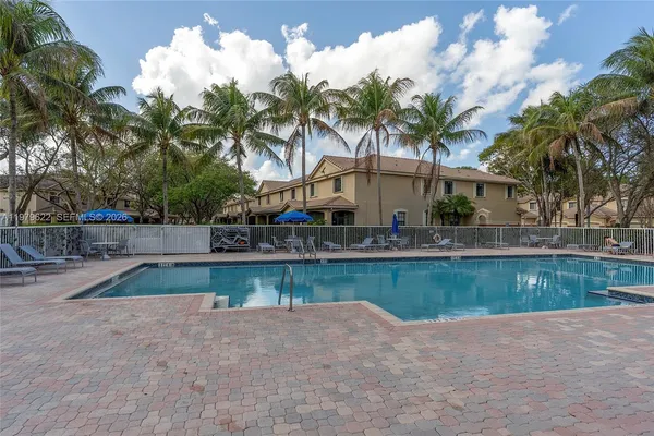 a view of a backyard and swimming pool
