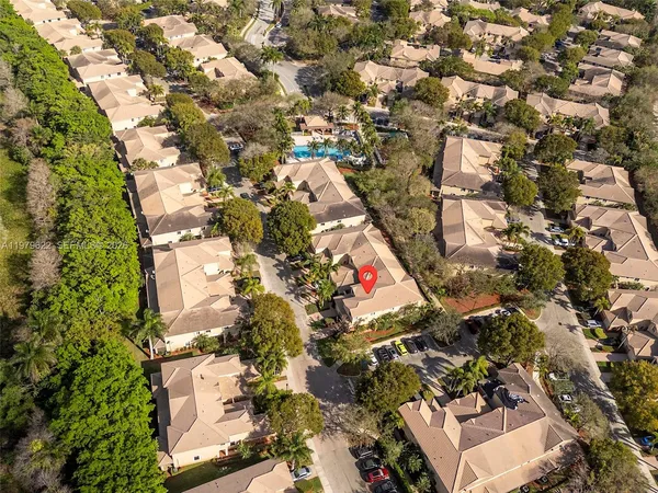 an aerial view of residential houses with outdoor space